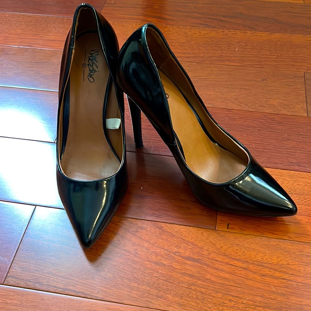 Woman’s black pumps.